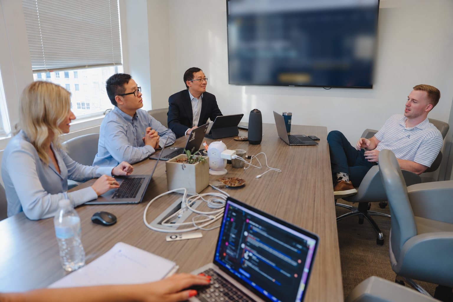The Whale Song team in a working session around a conference table, laptops open